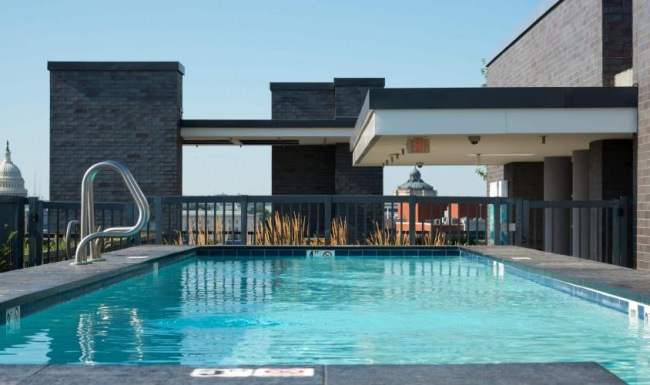 Resort-style swimming pool a swimming pool outside of a building